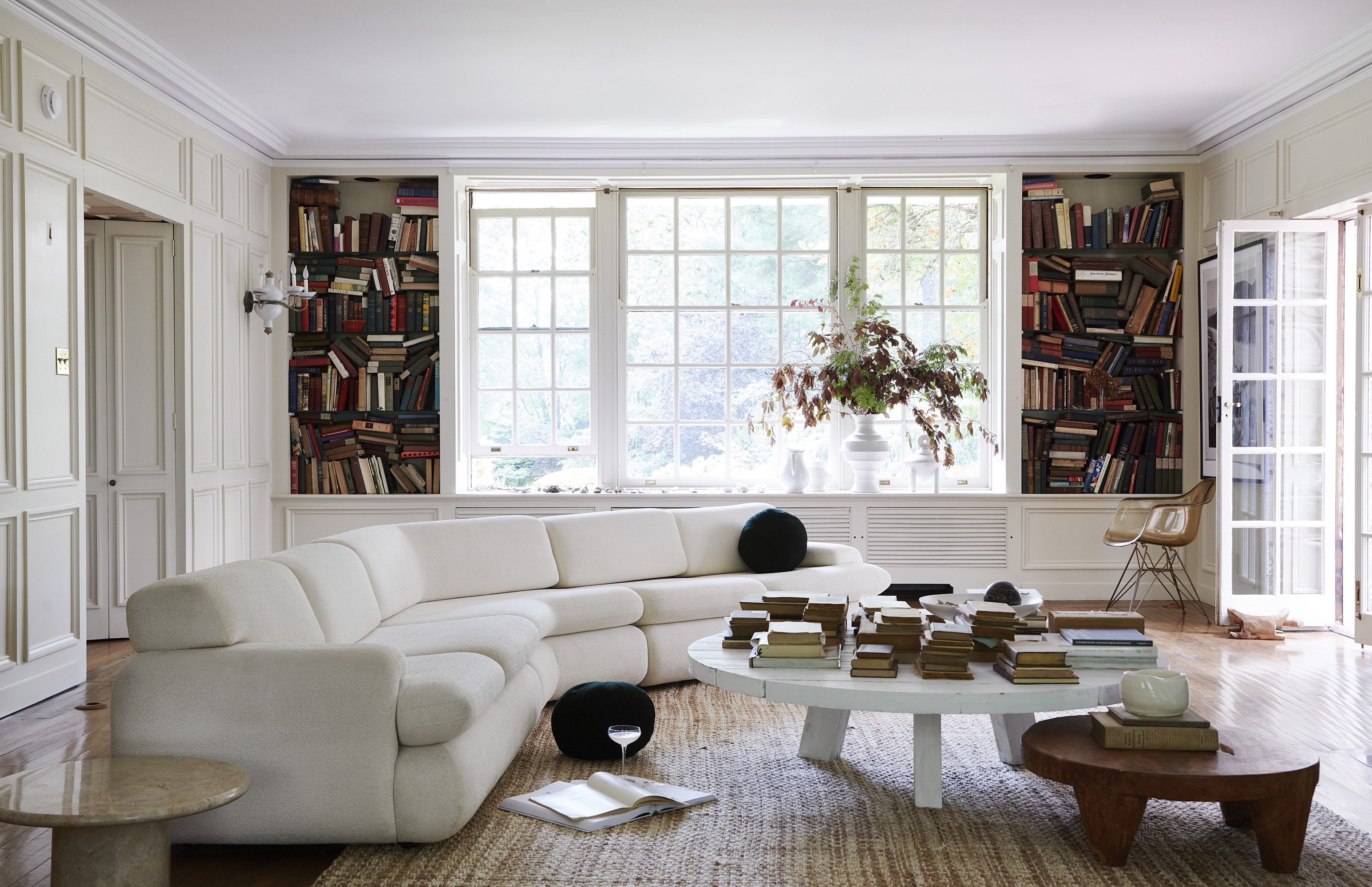 designer living room with featured white sofa and round coffee table