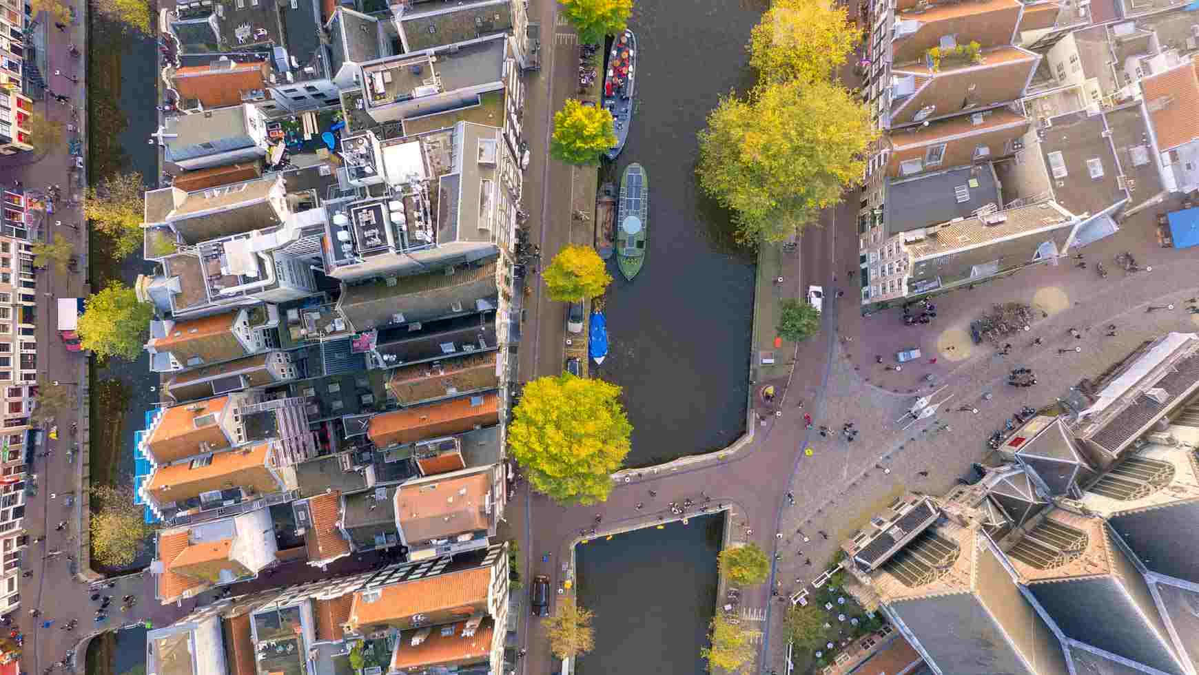 aerial view of boats on a canal running through a city