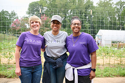 Trane Technologies Director of Global Citizenship Deidra Parrish Williams and her team members Amy Younger and China Antoine volunteering at the Urban Farm at Aldersgate